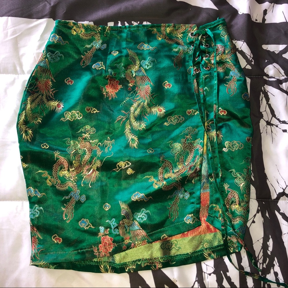 PrettyLittleThing green satin lace up mini skirt